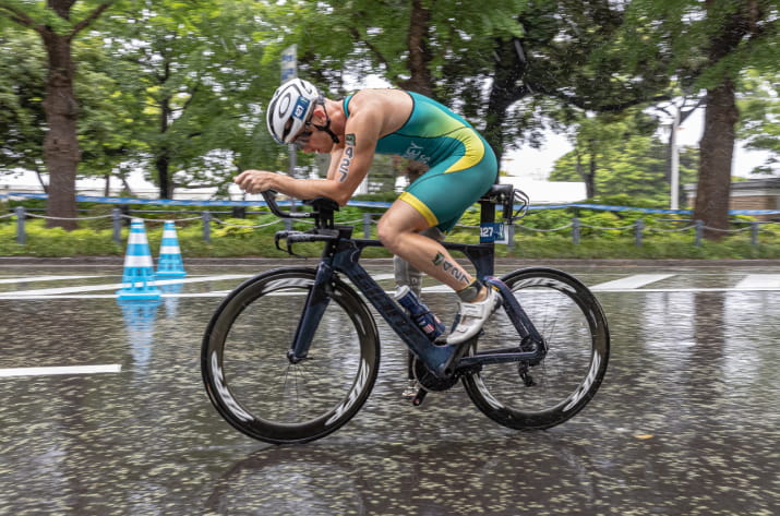 Liam Twomey cycling in a race while it's raining