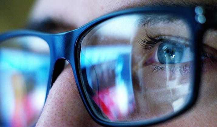 male wearing glasses close up