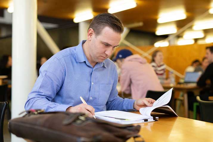 Open Universities Australia student David wearing professional clothes in a business setting.