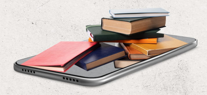 Books stacked on top of a laptop