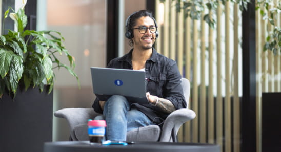 Open Universities Australia student advisor, Eddie, seated in the office.
